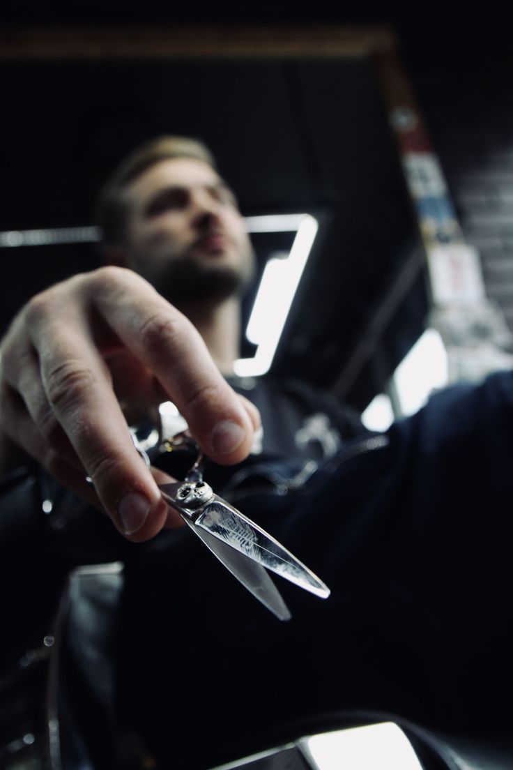 Professional barber providing precise beard grooming in a modern SB BarberShop-inspired setting