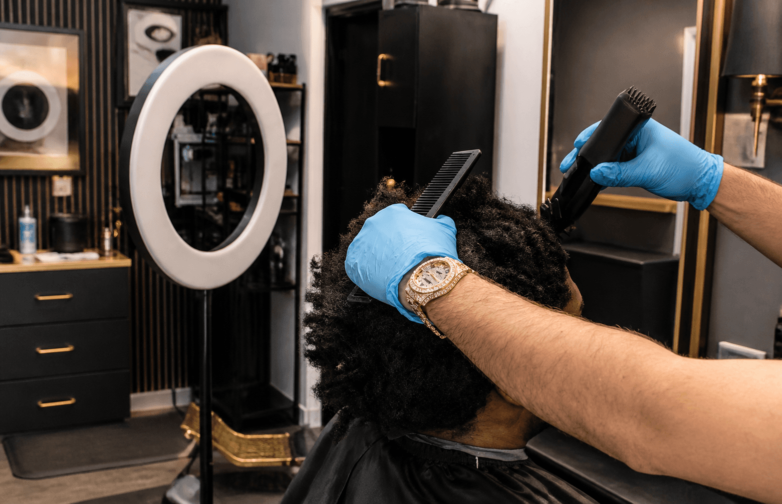 Client haircut in progress with blue gloves
